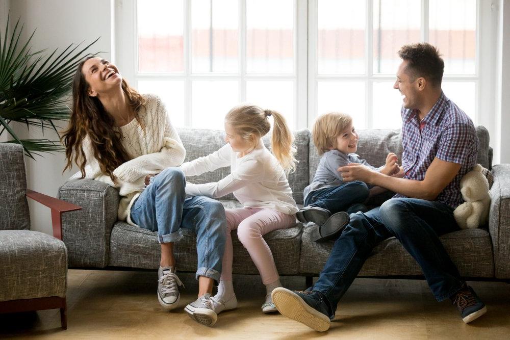 family at home breathing clean indoor air and having fun in the living room